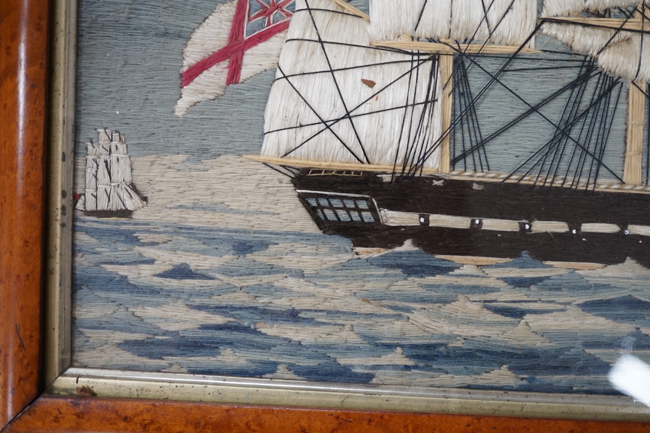 A maple framed 19th century wool work embroidery of a steam ship of the English fleet, 63cms wide, 47cms high